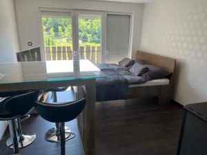 a bedroom with a bed and a desk and a table at Légy Ott Kuckó in Zalaszentlászló