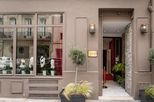 a store front with potted plants in front of it at Hôtel Churchill Bordeaux Centre in Bordeaux