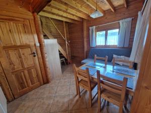 a dining room with a table and chairs in a cabin at Anna i Halina in Sztutowo +18 photos