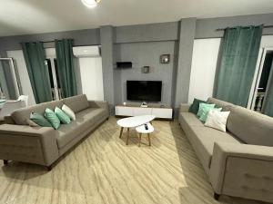 a living room with two couches and a tv at SWEET HOME 1 in Himare