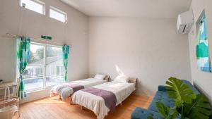 Postel nebo postele na pokoji v ubytování Beachside base KURUWA