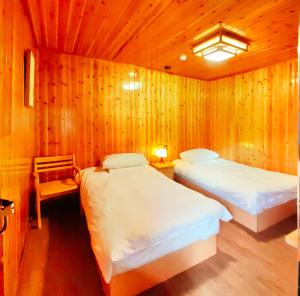 Ліжко або ліжка в номері Tulou Fuyulou Changdi Inn