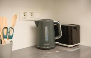an electric kettle sitting on a counter next to a toaster at Ormos Seaside Villas, by Amorgos Holiday Homes in Amorgos