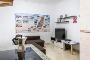 a living room with a couch and a table at Yesenia Vv Airport in El Matorral +18 photos
