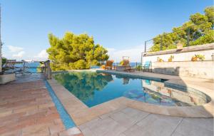 a swimming pool with blue water in a house at 5 Bedroom Stunning Home In Zman in Žman