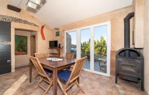 a dining room with a table and a wood stove at 5 Bedroom Stunning Home In Zman in Žman