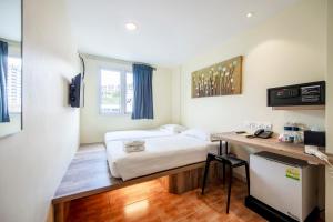 Postel nebo postele na pokoji v ubytování Fragrance Hotel - Balestier