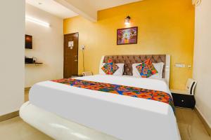 a bedroom with a large white bed in a room at Hotel Dewa - Nr Dabolim Airport in Vasco Da Gama