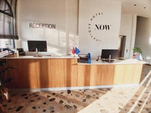 an office with a reception desk with two computers at Now Boutique Hotel in Erdemli