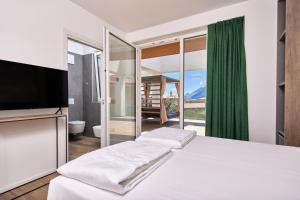 Postel nebo postele na pokoji v ubytování Hotel Catullo