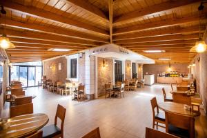 a restaurant with wooden ceilings and tables and chairs at Opatija Hotel in Istanbul
