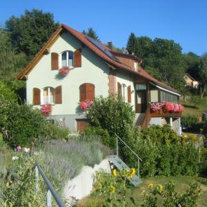 a house with a garden in front of it at Chambre d'hôte les écureuils in Goldbach