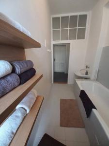 a white bathroom with towels and a bath tub at LP 1926 aneb U nás doma in Zlín