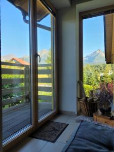a room with a window with a view of mountains at APARTMENT PRIVAT LUNA - Vysoké Tatry in Nová Lesná