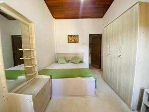 a small bedroom with a bed and a bunk room at Mountain Breeze Uplands in Kandy