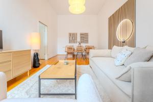a living room with a white couch and a table at Hakuna Cozy-Living city Center - free parking in Graz