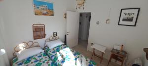 a bedroom with a bed with a comforter on it at boundless horizon potidea in Nea Potidaea