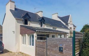 a house with a wooden fence in front of it at 4 Bedroom Gorgeous Home In Sibiril in Sibiril