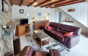 a living room with a leather couch and a tv at 4 Bedroom Gorgeous Home In Sibiril in Sibiril