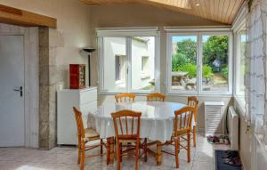a dining room with a white table and chairs at 4 Bedroom Gorgeous Home In Sibiril in Sibiril