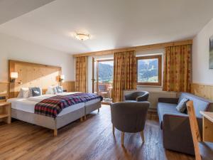 A bed or beds in a room at Hotel Alpenpanorama