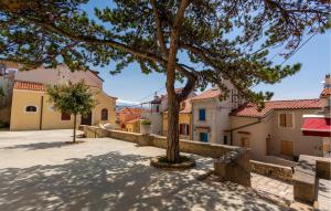 a tree in the middle of a street at 1 Bedroom Nice Apartment In Baska in Baška
