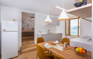 a kitchen and dining room with a table and chairs at 1 Bedroom Nice Apartment In Baska in Baška