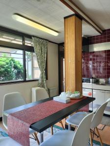 a kitchen with a dining room table and chairs at JOY HOUSE Near Ikebukuro in Tokyo