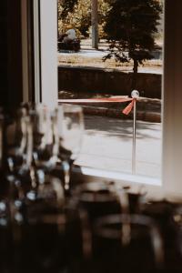 a view of a table with glasses and a window at Hostel ViktoryHome in Kryvyi Rih
