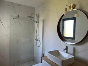 a bathroom with a sink and a mirror at Relax plage et bassin in Le Porge +14 photos