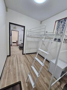 a bunk bed in a room with a ladder at 球美の駅 in Kumejima