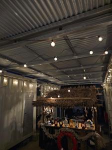 a room with a table with a chandelier at 球美の駅 in Kumejima