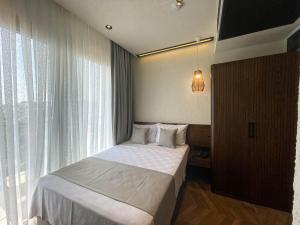Кровать или кровати в номере Now Boutique Hotel