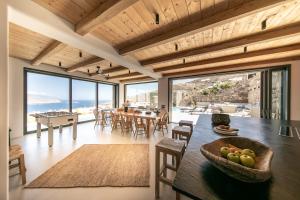 a kitchen and dining room with a table and chairs at Villa Joy Mykonos Boutique Hotel in Ano Mera