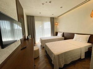 Кровать или кровати в номере Now Boutique Hotel