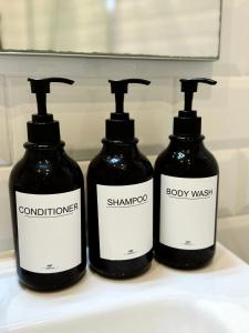 two bottles of shampoo and body wash on a sink at Stylish City Centre Studio - Grand Central House in Gibraltar