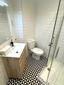 a bathroom with a toilet and a sink and a shower at Stylish City Centre Studio - Grand Central House in Gibraltar