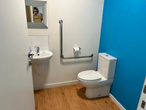a bathroom with a white toilet and a sink at Cbay Executive Accommodation in Timaru +14 photos