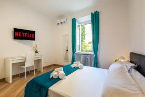a bedroom with a bed and a desk and a window at Alba Vatican Apartment in Rome