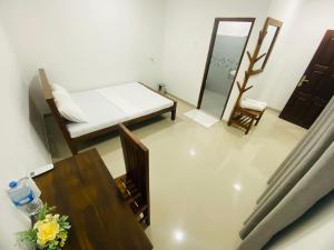 a living room with a bed and a table at Premium Cottages B&B in Kurunegala