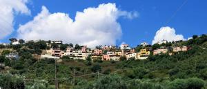 a group of houses on top of a hill at Rosemary Grand View in Exopoli