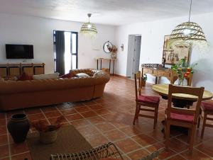 a living room with a couch and a table at Los Alcornoquillos in Carratraca