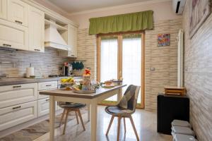 a kitchen with a table and chairs in a room at B&B Benvenuti al centro in Caserta