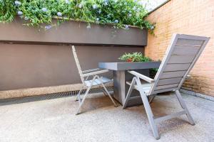 a desk and a chair next to a table and a plant at Città Studi Suites - Top Collection in Milan