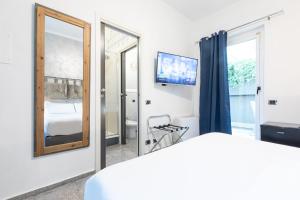a bedroom with a mirror and a bed and a tv at Città Studi Suites - Top Collection in Milan