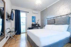 a bedroom with a large white bed and a window at Città Studi Suites - Top Collection in Milan