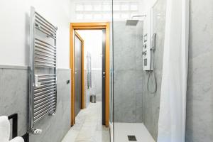 a bathroom with a shower and a glass door at Città Studi Suites - Top Collection in Milan