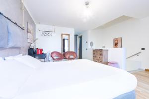 a bedroom with a bed and two chairs at Città Studi Suites - Top Collection in Milan