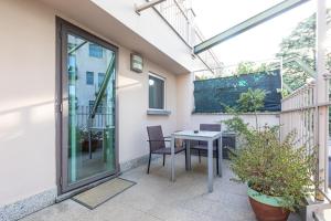 a patio with a table and chairs on a balcony at Città Studi Suites - Top Collection in Milan