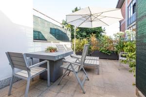 a table and chairs with an umbrella on a patio at Città Studi Suites - Top Collection in Milan